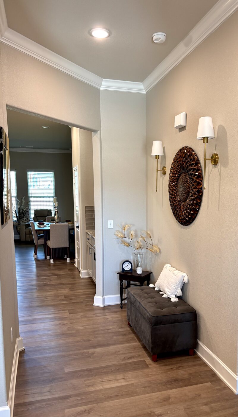 Entry hallway with warm lighting and wood floors