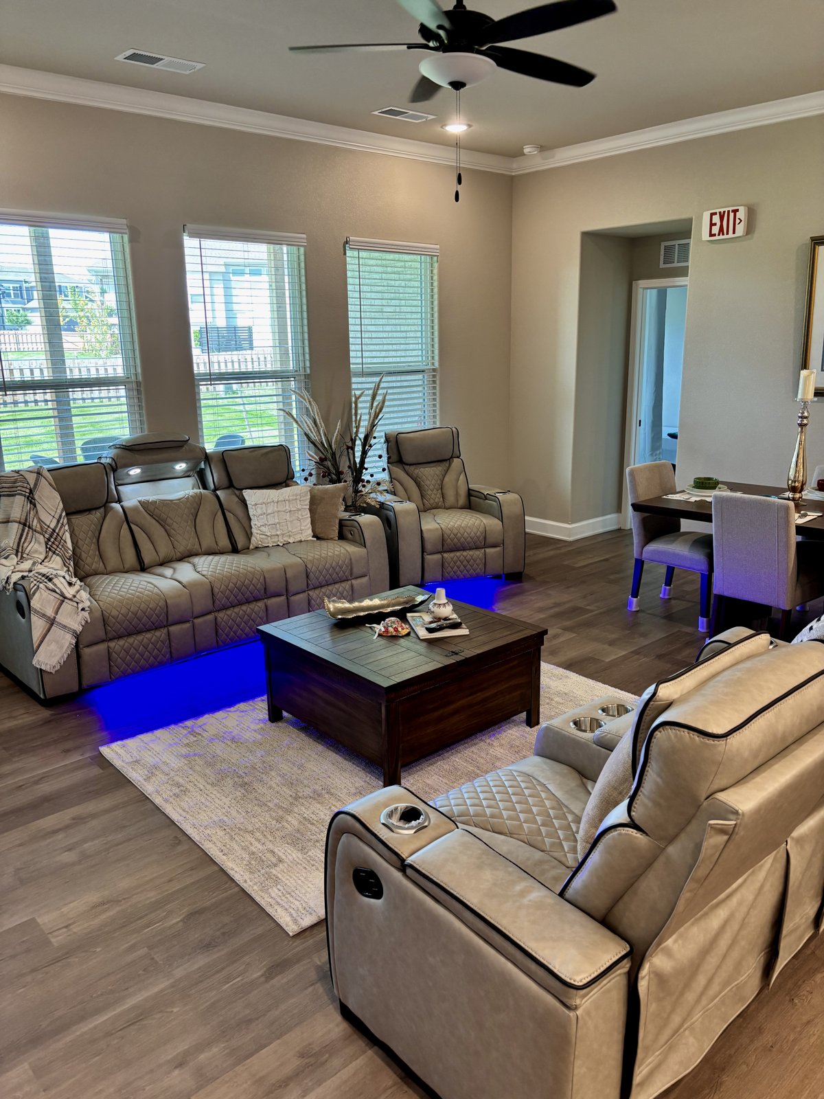 Living room with reclining sofas and a view into the dining area